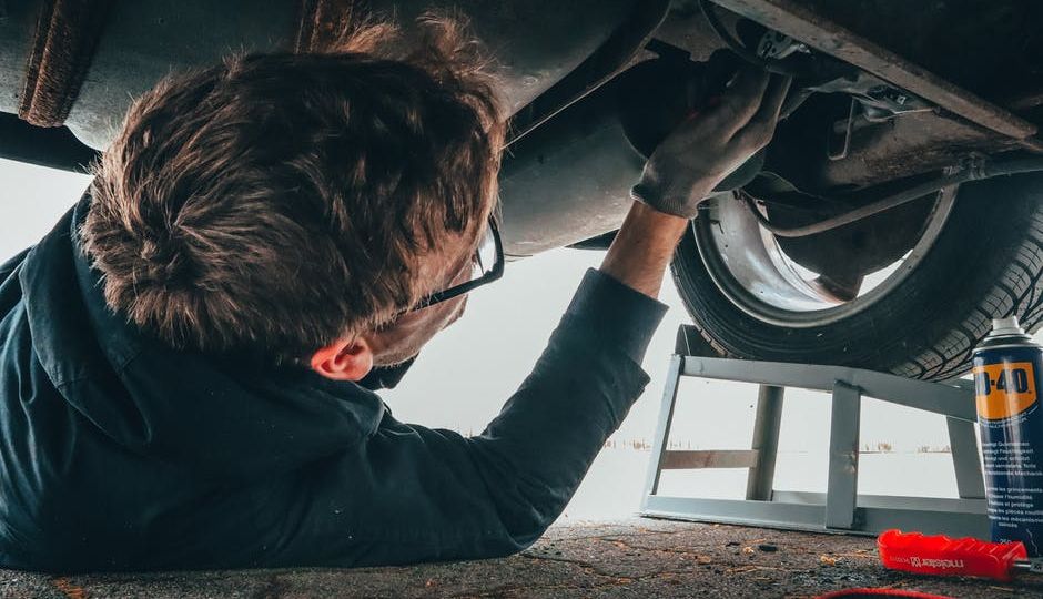 auto mechanic working on car